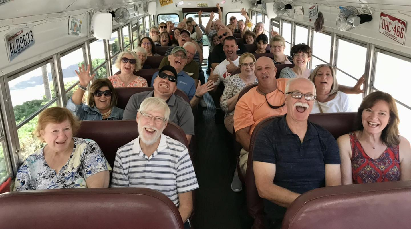 People laughing seated in a bus
